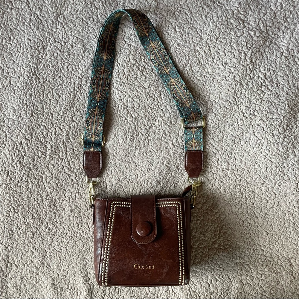 Brown leather bucket bag with patterned strap